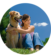 A Girl sitting and hugging her dog in Flea Control Lawn 