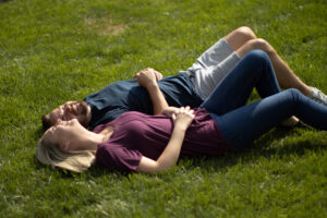 Couple laying on grass after Lawn Doctor provided Residential Lawn Care in Gainesville