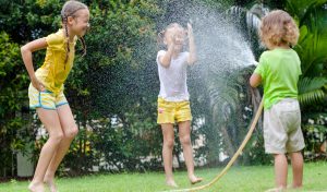 Children playing in water in a lawn with all Service of Falls Church