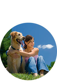 Girl sitting and hugging her dog on lawn after Lawn Doctor provided Flea Control in Bernardsville