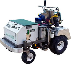 lawn aeration lawn care machine on wheels labeled Turf Tamer