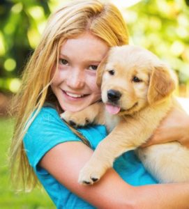 girl holding puppy
