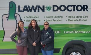 Lawn Doctor of Doylestown office employees by van