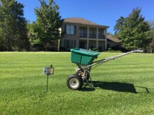 seeding machine sitting on grass treated by lawn services in Columbus