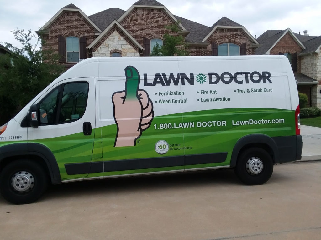 Lawn Doctor of Cypress van parked outside of a large house getting ready for their lawn services