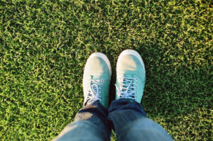 Shoes on top of grass after Lawn Doctor provided Grass Care in Copperfield