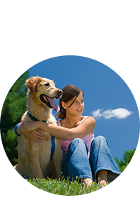 Post image Girl sitting and hugging her dog on lawn
