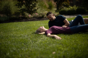 Couple enjoying on green grass after lawn treatment in Burlington
