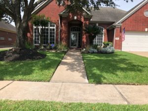 Beautiful front lawn of a house after lawn care service Saratoga Springs