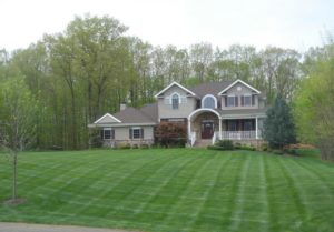 Large green front lawn showing lawn treatments in Little Rock