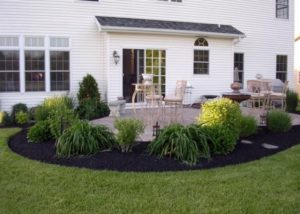 manicured green back yard with fountain