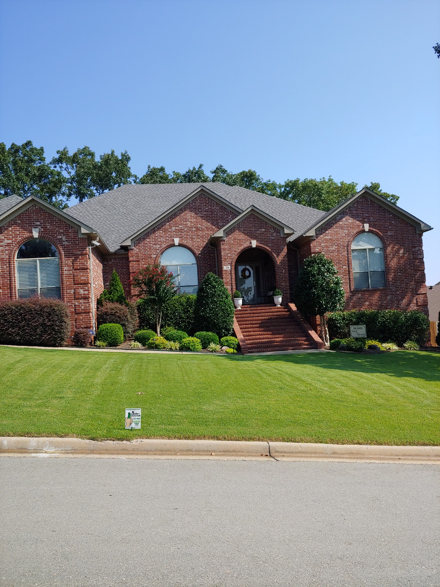 Large front yard with sign for yard of the month showing lawn services in Little Rock, AR