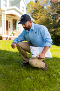 Lawn Doctor expert checking during weed control in Janesville