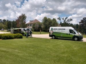 lawn doctor trucks in front of yard showing lawn care in mandeville