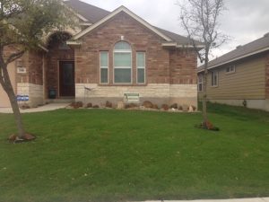 quality lawn care in front of brick house