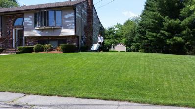 Man using power seeder for lawn enrichment as a lawn specialist in Peabody