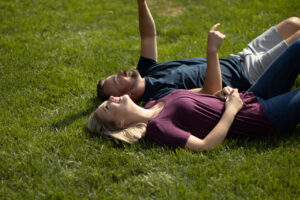 Couple laying on grass after Lawn Doctor provided Residential Lawn Care in Sun City Center