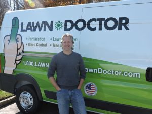 Lawn Doctor franchisee in front of service truck