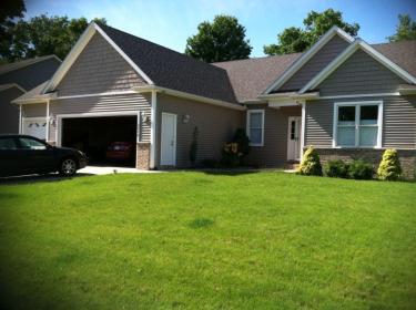 beautiful green front lawn showing lawn care in Portage