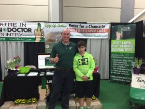 father and son at lawn doctor convention booth