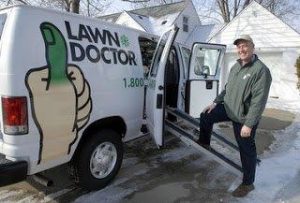 man standing next to lawn doctor van