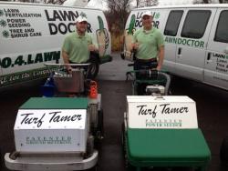 employees holding turf tamer machines for lawn seeding in Portage