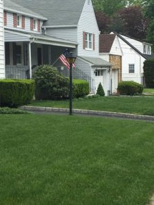 beautiful green front yard showing lawn treatment in Rockaway