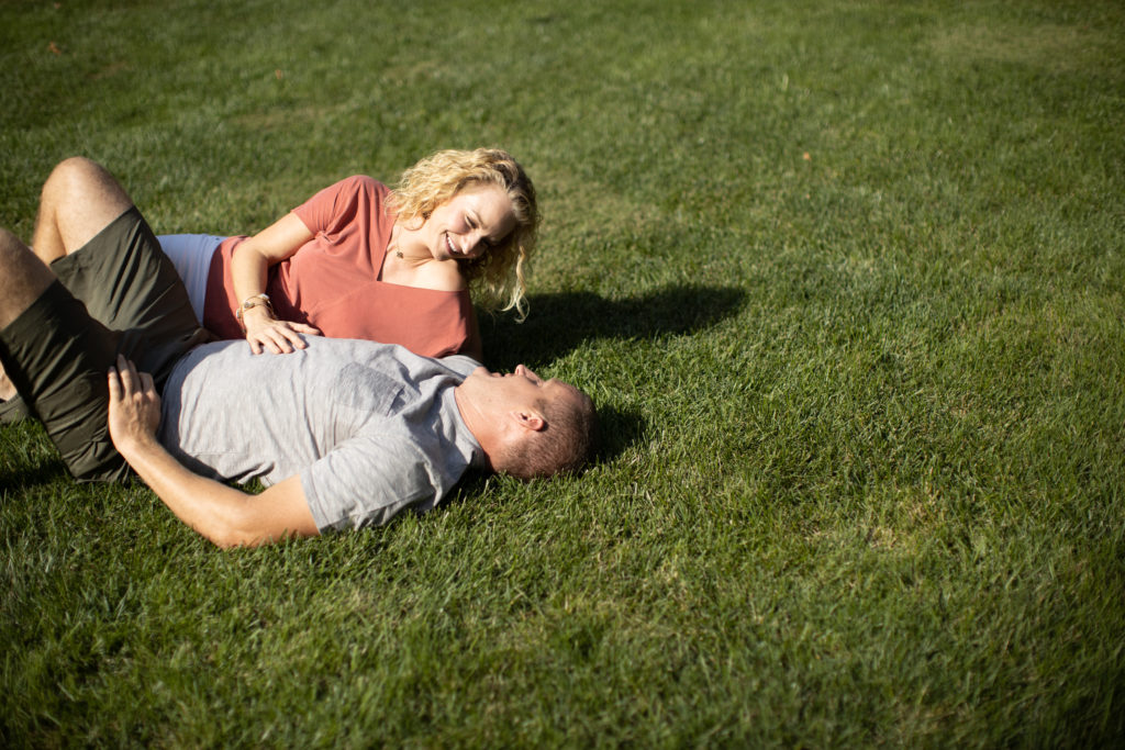 Couple laying on grass after Lawn Doctor provided Yard Care in Heath