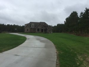 Beautifully manicured front lawn with house in the background showing lawn services in Fuquay Varina