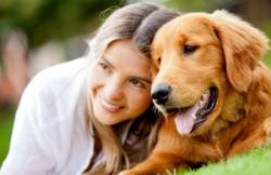 girl with golden retriever happy that her family choose lawn doctor as their lawn care company