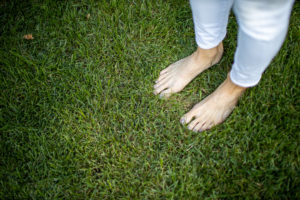 Feet in grass after Lawn Doctor provided Lawncare Service in Millsboro