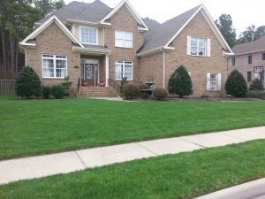 Fresh new lawn in front of house showing Green Grass in Virginia Beach
