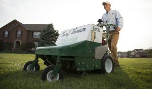 lawn doctor expert performing lawn seeding lawn service on yard