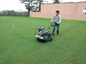 lawn aeration work by lawn technician