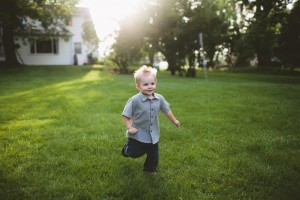 young child plays in lawn
